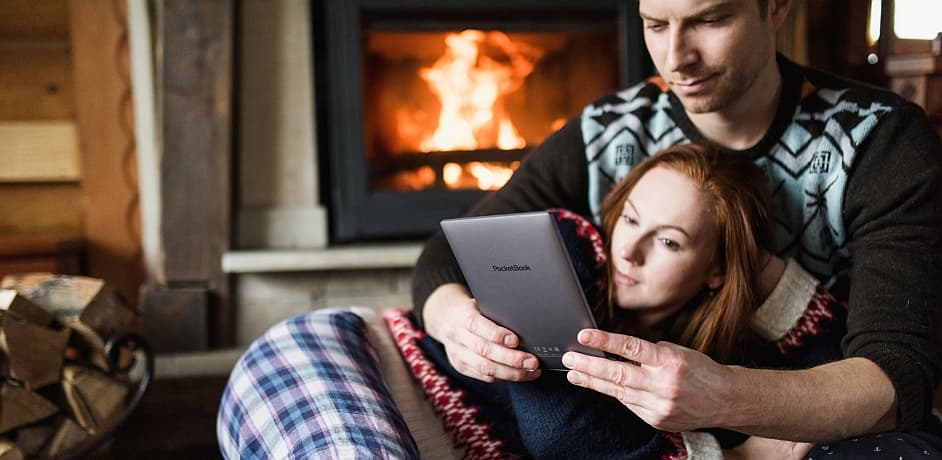 PocketBook Partnerprogramm Buchhandlungen Ein Foto von zwei Personen vorm Kaminfeuer mit einem E-Reader in der Hand